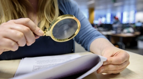 Woman looking through magnifying glass.jpg